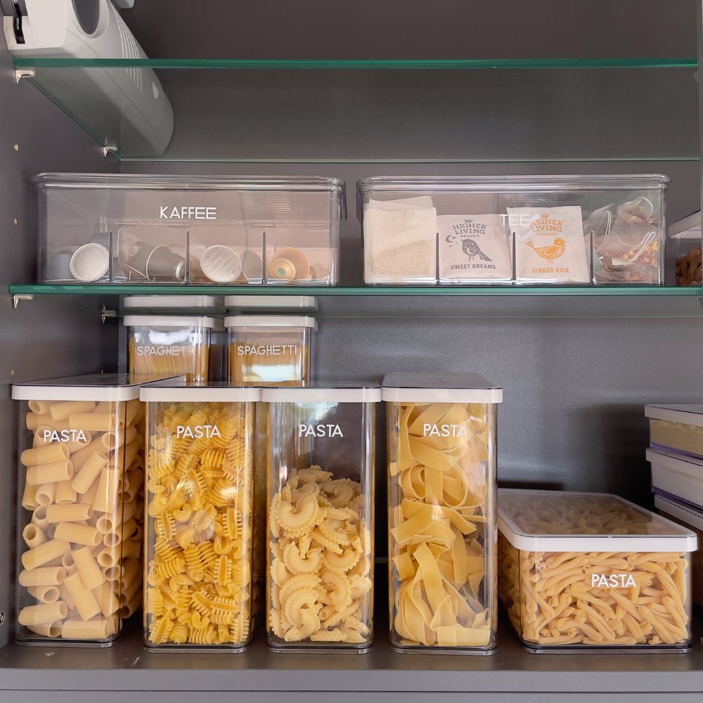 Containers with coffee capsules, tea bags, and pasta on the shelf, texts: "COFFEE," "TEA," "PASTA," "SPAGHETTI."